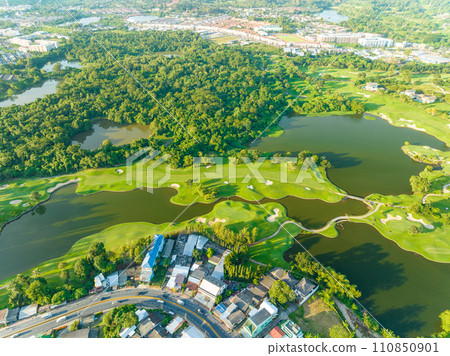 Aerial view of beautiful green golf field fairway and putting green, Top down image for sport background and travel nature background, Amazing  green nature view 110850901