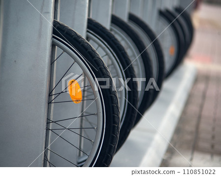 Bicycle wheels with orange reflectors in the parking lot Bicycle wheels with orange reflectors in the parking lot 110851022