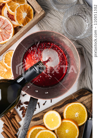 Making mulled wine in home kitchen Making mulled wine in home kitchen 110851382