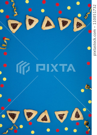 Hamantaschen Cookies, Carnival Mask, Noisemaker on Blue Background. Purim Celebration, Jewish Carnival Holiday Concept. Hamantaschen Cookies, Carnival Mask, Noisemaker on Blue Background. Purim Celebration, Jewish Carnival Holiday Concept. 110851732