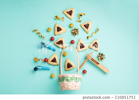 Purim Jewish Hamantaschen Cookies, Carnival Mask, Noisemaker on Blue Mint Green Background. Purim Celebration, Jewish Carnival Holiday Concept. 110851751