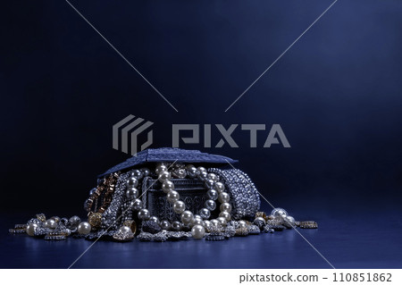 Various jewels in a silver box on black background 110851862