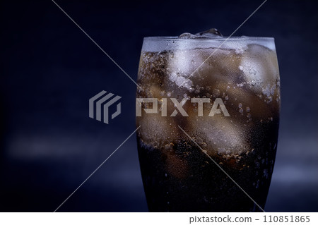 Cool glass of cola drink with ice, bubbles and fizz Cool glass of cola drink with ice, bubbles and fizz 110851865