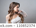 The bride with a beautiful hairstyle decorated with pearls looks away. 110852374