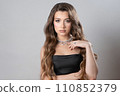 A beautiful girl with a ring and a necklace made of pearls and precious stones. 110852379