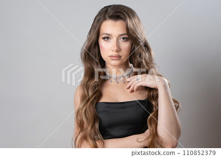 A beautiful girl with a ring and a necklace made of pearls and precious stones. A beautiful girl with a ring and a necklace made of pearls and precious stones. 110852379
