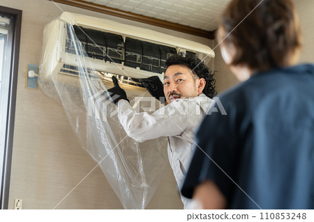 Client receiving an explanation of the condition of the air conditioner Client receiving an explanation of the condition of the air conditioner 110853248