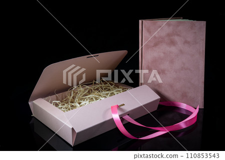 Best gift for men. Man gift concept. Pink notebook with Pink gift box on black background. Copy space text. Valentine's day, wedding, birthday and special occasion gift concept. Copy space for text. 110853543