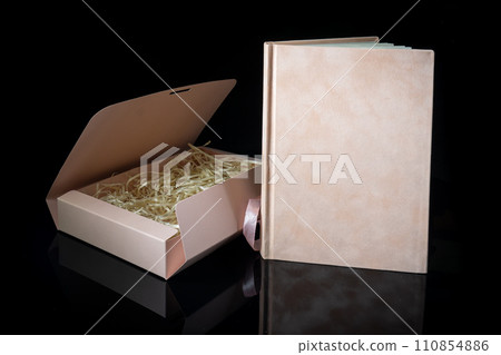 Best gift for men. Man gift concept. Pink notebook with Pink gift box on black background. Copy space text. Valentine's day, wedding, birthday and special occasion gift concept. Copy space for text. Best gift for men. Man gift concept. Pink notebook with Pink gift box on black background. Copy space text. Valentine's day, wedding, birthday and special occasion gift concept. Copy space for text. 110854886