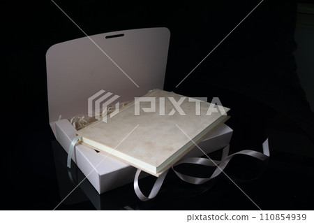 Best gift for men. Man gift concept. Pink notebook with Pink gift box on black background. Copy space text. Valentine's day, wedding, birthday and special occasion gift concept. Copy space for text. Best gift for men. Man gift concept. Pink notebook with Pink gift box on black background. Copy space text. Valentine's day, wedding, birthday and special occasion gift concept. Copy space for text. 110854939