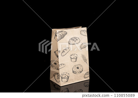 Recyclable craft paper bag for purchases, gifts and takeaway food mock up on black background. Environmentally friendly than single-use plastic bags 110855089
