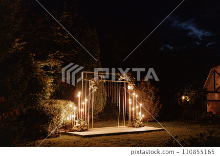 Wedding arch on the street with garlands at night. 110855165