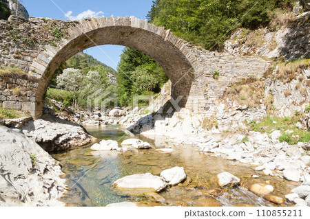 Ancient Roman bridge along the road to Anso, Spain. Ordesa valley Ancient Roman bridge along the road to Anso, Spain. Ordesa valley 110855211