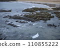 Detail of a sandy and rocky beach with calm waters. 110855222