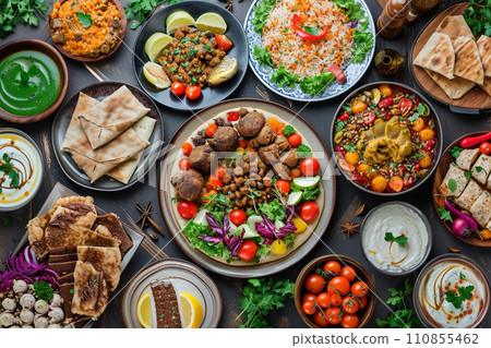 Flat lay of Ramadan kareem Iftar party table with assorted festive traditional Arab dishes Flat lay of Ramadan kareem Iftar party table with assorted festive traditional Arab dishes 110855462