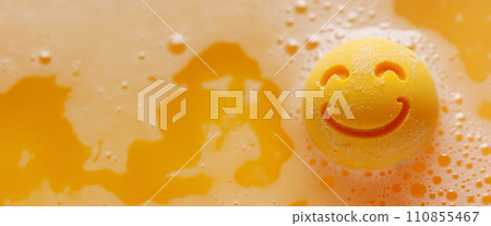 Orange bath bomb in water with happy smile 110855467