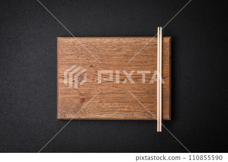 Light wooden chopsticks on a blank background as a backdrop for an Asian dish 110855590