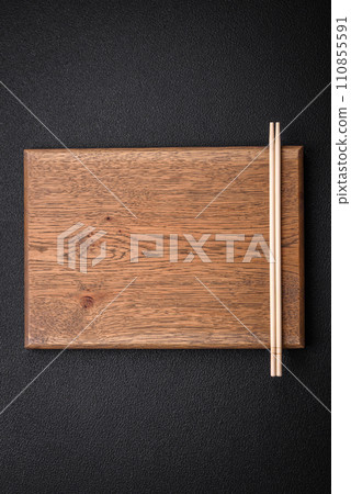 Light wooden chopsticks on a blank background as a backdrop for an Asian dish 110855591