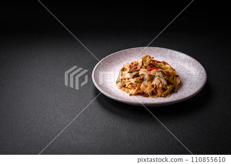 Delicious Asian dish udon with hot peppers, green beans, spices and herbs 110855610