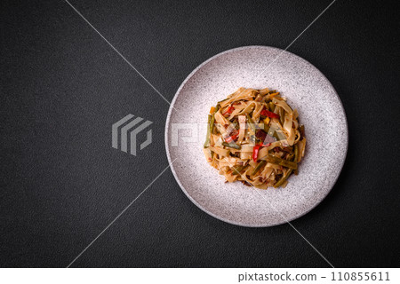 Delicious Asian dish udon with hot peppers, green beans, spices and herbs 110855611