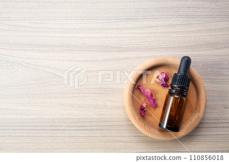 Alternative medicine. Endobiogenics, new look at medicine, bottle of essential oil on wooden background. Copy space Alternative medicine. Endobiogenics, new look at medicine, bottle of essential oil on wooden background. Copy space 110856018