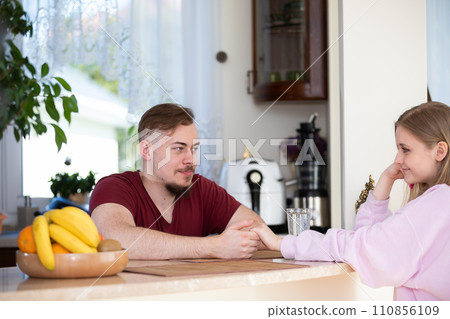 A couple in love sits across from each other and looks deeply into each other's eyes. A couple in love sits across from each other and looks deeply into each other's eyes. 110856109