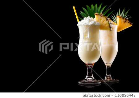 Set of Pina Colada with pineapple, coconut and creamy white top presented in a chilled glass with straw 110856442