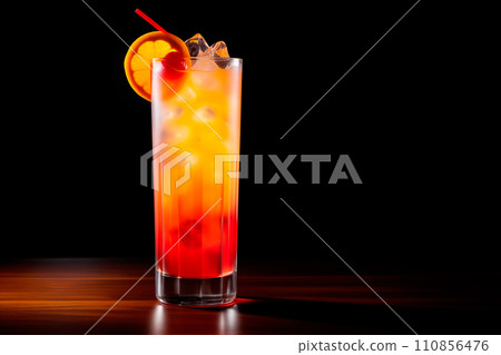 Tequila Sunrise cocktail blend of tequila, orange juice, and grenadine on black 110856476
