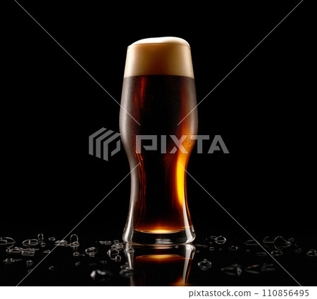 Beer in a tall glass on a dark black background. Mugs with drink like Ipa, Pale Ale, Pilsner, Porter or Stout 110856495