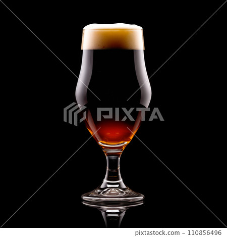 Beer in a tall glass on a dark black background. Mugs with drink like Ipa, Pale Ale, Pilsner, Porter or Stout Beer in a tall glass on a dark black background. Mugs with drink like Ipa, Pale Ale, Pilsner, Porter or Stout 110856496