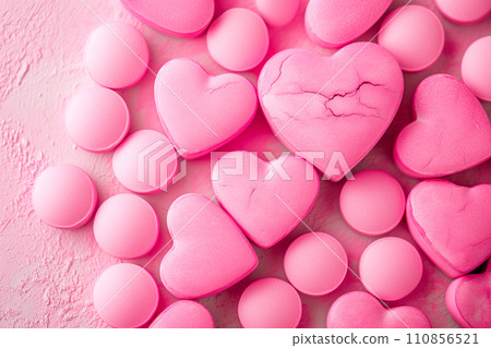 Closeup of pink candy hearts and sweets in shape of love symbol on pink background, for Valentine's day Closeup of pink candy hearts and sweets in shape of love symbol on pink background, for Valentine's day 110856521