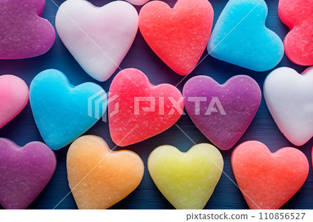 Closeup of pink candy hearts and sweets in shape of love symbol on pink background, for Valentine's day Closeup of pink candy hearts and sweets in shape of love symbol on pink background, for Valentine's day 110856527