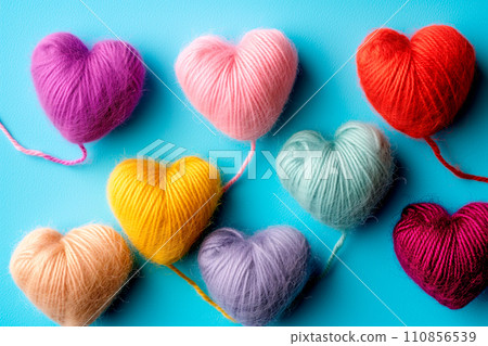 Poster or banner of colorful yarn hearts on surface on a blue background, Vibe of st. Valentine day and romantic Poster or banner of colorful yarn hearts on surface on a blue background, Vibe of st. Valentine day and romantic 110856539