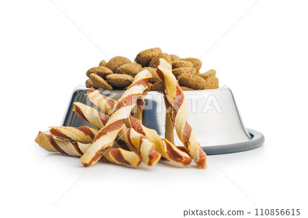 Dog food. Snack sticks for dogs in bowl isolated on white background. Dog food. Snack sticks for dogs in bowl isolated on white background. 110856615