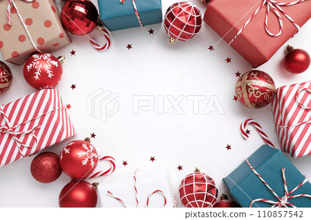Christmas frame with gift boxes and balls on white 110857542