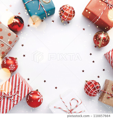 Christmas frame with gift boxes and balls on white Christmas frame with gift boxes and balls on white 110857664