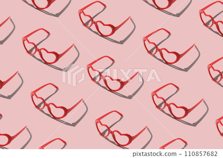 Pattern made with red heart shaped sunglasses on pastel color background Pattern made with red heart shaped sunglasses on pastel color background 110857682