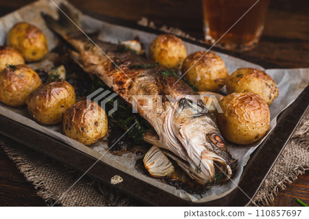 Fish Baked with Sorrel and New Potatoes 110857697