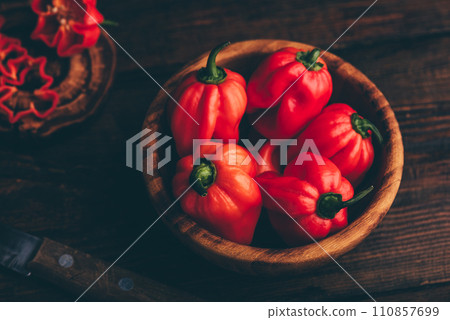 Red Habanero Chili Peppers in a Wooden Bowl 110857699