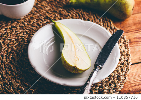 Halved Green Pear on Plate Halved Green Pear on Plate 110857716