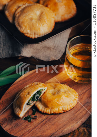 Freshly Baked Hand Pies Filled with Blue Chives and Mushrooms and Sliced One Pie Freshly Baked Hand Pies Filled with Blue Chives and Mushrooms and Sliced One Pie 110857733