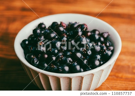 Bowl Full of Ripe Purple Amelanchier Berries 110857737