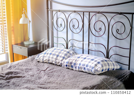 A bed with pillows on it in the room. Interior photography A bed with pillows on it in the room. Interior photography 110858412