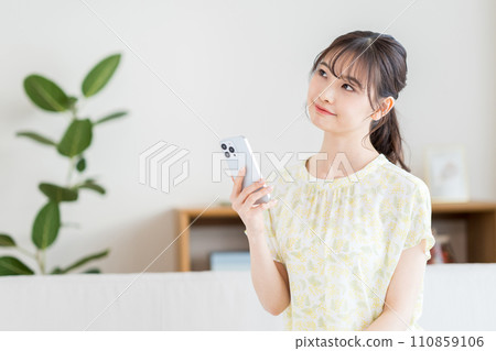 A woman operating a smartphone. A woman operating a smartphone. 110859106