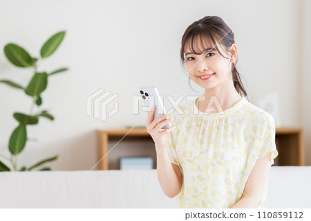 A woman operating a smartphone. A woman operating a smartphone. 110859112
