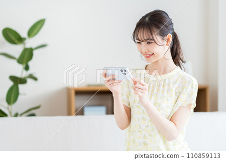 A woman operating a smartphone. A woman operating a smartphone. 110859113