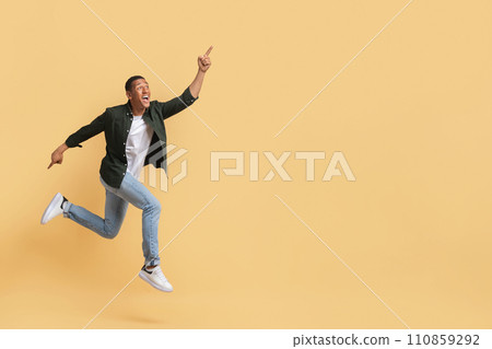 Happy black guy running towards copy space 110859292