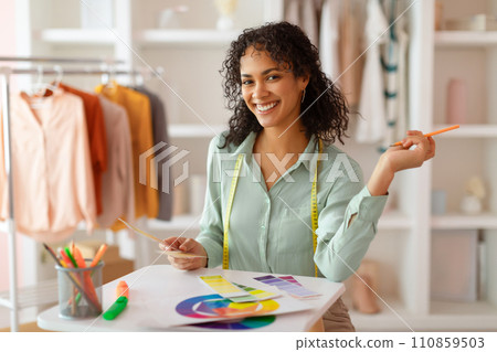 Creative designer with color swatches planning in studio Creative designer with color swatches planning in studio 110859503