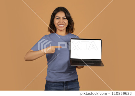 Happy young arab woman showing laptop with white screen 110859623