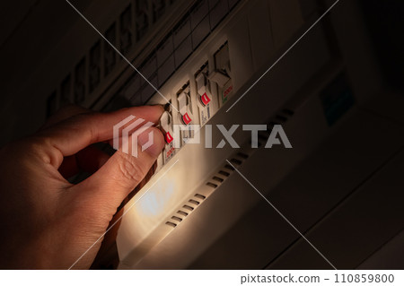 Operate the breaker switch in a dark room 110859800